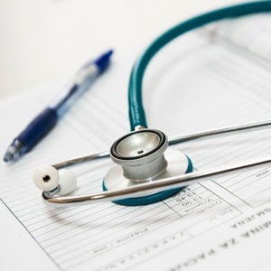 Un bolí y aparato médico sobre una hoja de evidencias científicas