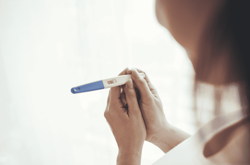 Mujer sostiene en sus manos un test de embarazo